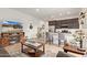 Open-concept living space with modern kitchen, entertainment center, and cozy seating arrangement at 24327 N 163Rd Dr, Surprise, AZ 85387