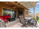 Outdoor patio with a cozy seating area and barbecue, perfect for relaxing or entertaining guests at 24327 N 163Rd Dr, Surprise, AZ 85387
