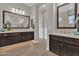 Bathroom featuring double vanities with framed mirrors and modern lighting fixtures at 2546 E Russell St, Mesa, AZ 85213