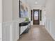 Inviting entryway featuring decorative front door, stylish console table and eye-catching artwork at 2546 E Russell St, Mesa, AZ 85213