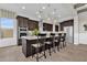 Spacious kitchen with dark wood cabinets, stainless steel appliances, large island, and breakfast bar at 2546 E Russell St, Mesa, AZ 85213