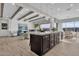 Open kitchen and living space with a large island, modern pendants, and stainless steel appliances at 2546 E Russell St, Mesa, AZ 85213