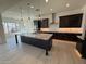 This stunning kitchen features an oversized island, stainless hood, and modern dark cabinetry at 2546 E Russell St, Mesa, AZ 85213