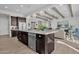Kitchen island with dark cabinets, light countertops, stainless steel appliances, and pendant lighting at 2546 E Russell St, Mesa, AZ 85213