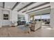 Open concept living area featuring wood beams, bright furnishings, and seamless indoor-outdoor flow at 2546 E Russell St, Mesa, AZ 85213