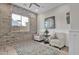 Cozy sitting area with brick accent wall, patterned chairs, and decorative rug at 2546 E Russell St, Mesa, AZ 85213