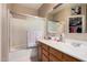 Bathroom showcasing a shower-tub combo with glass enclosure and white vanity at 2635 E Riviera Dr, Chandler, AZ 85249