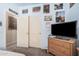 Bedroom with pale blue walls, carpet floors, and a dresser with a flat screen TV at 2635 E Riviera Dr, Chandler, AZ 85249