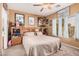 Cozy bedroom features a ceiling fan, carpet floors, natural light, and eclectic decor at 2635 E Riviera Dr, Chandler, AZ 85249