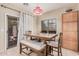 Bright dining area with tile floors, a wooden table, and a sliding glass door that leads to the backyard at 2635 E Riviera Dr, Chandler, AZ 85249