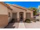 Low angle view of a home's front entrance featuring desert landscaping and a secured front door with sidelight windows at 2635 E Riviera Dr, Chandler, AZ 85249