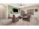 Living room with plush furniture, carpet flooring, a ceiling fan, and natural light filtering through the windows at 2635 E Riviera Dr, Chandler, AZ 85249
