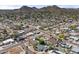 Aerial view of homes in the neighborhood surrounded by mountains and palm trees showcases community charm at 2902 E Corrine Dr, Phoenix, AZ 85032