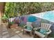 Private backyard oasis featuring beautiful flower paintings on the wall and relaxing seating at 2902 E Corrine Dr, Phoenix, AZ 85032