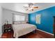 Comfortable bedroom with hardwood flooring, ceiling fan and king sized bed at 2902 E Corrine Dr, Phoenix, AZ 85032