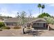 Charming single-story home featuring desert landscaping, brick accents, and a covered carport at 2902 E Corrine Dr, Phoenix, AZ 85032