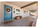 Welcoming front porch features a vibrant blue door and ample space for decor at 2902 E Corrine Dr, Phoenix, AZ 85032