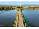 Scenic aerial view of a road surrounded by water, green foliage, and a mountain view in the distance at 3003 E Ironside Ln, Gilbert, AZ 85298