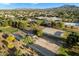 Aerial view of a neighborhood with a school, desert landscaping, playground, and mountain backdrop at 3003 E Ironside Ln, Gilbert, AZ 85298