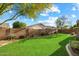 Green backyard with lush lawn, brick walls, landscaping, and plenty of sunshine at 3003 E Ironside Ln, Gilbert, AZ 85298