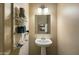 A pedestal sink and mirror create a functional space with decorative touches enhancing the room's charm at 3003 E Ironside Ln, Gilbert, AZ 85298
