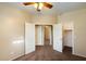 Spacious bedroom with three open doorways, neutral walls, carpet, and overhead lighting at 3003 E Ironside Ln, Gilbert, AZ 85298