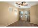 A bedroom with three windows with plaid curtains provide ample natural light, complemented by a ceiling fan at 3003 E Ironside Ln, Gilbert, AZ 85298