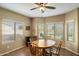 Cozy dining area with a wooden table set, surrounded by bright windows overlooking the landscaped yard at 3003 E Ironside Ln, Gilbert, AZ 85298