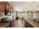 Well-equipped kitchen boasting dark wood cabinetry, modern appliances, and a seamless flow into the breakfast nook at 3003 E Ironside Ln, Gilbert, AZ 85298