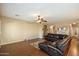 A spacious living room with beautiful hardwood floors, and stylish leather furniture at 3003 E Ironside Ln, Gilbert, AZ 85298