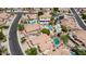 Aerial view featuring homes, swimming pools, desert landscaping, well-kept lawns, and palm trees at 3166 E Desert Willow Rd, Phoenix, AZ 85048