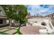 Spacious backyard featuring a built-in grill, pizza oven, manicured landscaping, and charming string lights at 3166 E Desert Willow Rd, Phoenix, AZ 85048