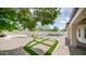 Expansive backyard featuring custom brickwork, artificial turf accents, and a built-in seating area with a pizza oven at 3166 E Desert Willow Rd, Phoenix, AZ 85048