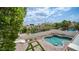 Backyard showcasing a lovely pool with rock waterfall feature, lush landscaping, and paved patio at 3166 E Desert Willow Rd, Phoenix, AZ 85048