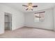 Comfortable bedroom features a ceiling fan, closet, and window offering outdoor views at 3166 E Desert Willow Rd, Phoenix, AZ 85048