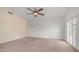 Large bedroom featuring neutral carpet, ceiling fan, and shuttered window for natural light and privacy at 3166 E Desert Willow Rd, Phoenix, AZ 85048