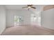 Spacious bedroom featuring a ceiling fan, vaulted ceiling, and access to the outdoor patio at 3166 E Desert Willow Rd, Phoenix, AZ 85048