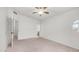Spacious bedroom boasting a ceiling fan and an attached bathroom, providing comfort and privacy at 3166 E Desert Willow Rd, Phoenix, AZ 85048