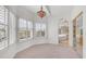 Bedroom with neutral carpet, beautiful lighting, and windows with views of the lush outdoors at 3166 E Desert Willow Rd, Phoenix, AZ 85048