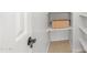 Linen closet with white shelving and a decorative wicker basket at 3166 E Desert Willow Rd, Phoenix, AZ 85048