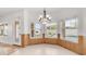 Bright dining room with wood paneled walls, a stylish chandelier and view of the backyard at 3166 E Desert Willow Rd, Phoenix, AZ 85048
