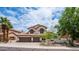 Beautiful two-story home with a tile roof, arched windows, and a three-car garage at 3166 E Desert Willow Rd, Phoenix, AZ 85048