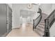 Bright foyer features a grand curved staircase, designer lighting and neutral tile flooring at 3166 E Desert Willow Rd, Phoenix, AZ 85048