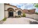Inviting front entrance featuring double doors, manicured landscaping, and a paver driveway at 3166 E Desert Willow Rd, Phoenix, AZ 85048