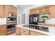 The gourmet kitchen features stainless steel appliances, including a double oven and electric cooktop at 3166 E Desert Willow Rd, Phoenix, AZ 85048
