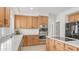Bright kitchen features light wood cabinets, quartz countertops and stainless steel appliances at 3166 E Desert Willow Rd, Phoenix, AZ 85048