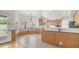 Bright kitchen and breakfast nook featuring wood cabinets, light countertops, tile flooring and views of an outdoor waterfall at 3166 E Desert Willow Rd, Phoenix, AZ 85048