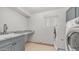 Functional laundry room with modern machines, sink, and storage for added convenience at 3166 E Desert Willow Rd, Phoenix, AZ 85048