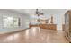 Open concept living room with hardwood floors, view of the kitchen and dining room and a covered patio at 3166 E Desert Willow Rd, Phoenix, AZ 85048