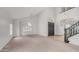 Spacious living room with ample natural light, plush carpeting, and access to the staircase at 3166 E Desert Willow Rd, Phoenix, AZ 85048